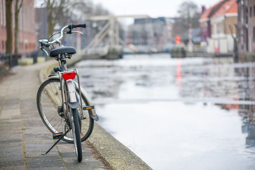 Bike by a canal in Gouda - Netherlands