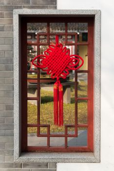 Red chinese lanterns decoration on a traditional window in Baihuatan public park Chengdu China for the Chinese new year celebrations.