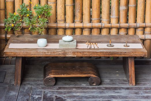 Wooden table with traditional chinese set of tools to prepare tea, Chengdu, China