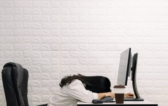 A woman sleeping on the desk Computer screen