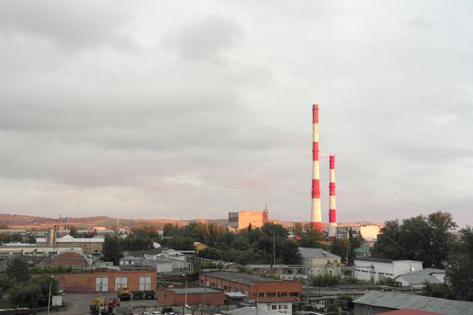 Evening industrial landscape with factory chimneys