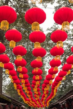 Rows of red chinese lanterns hanging in a street for the chinese new year