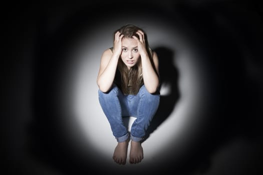 Unhappy Woman Sitting In Pool Of Light