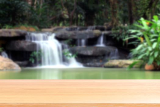 wood plank on blurred waterfall beautiful nature background, empty wood table floors on nature waterfall fresh, wood table board empty on garden waterfall in suan luang rama IX (9) bangkok thailand