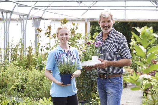 Portrait Of Male Customer With Sales Assistant At Garden Center