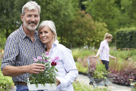 Portrait Of Mature Couple Shopping At Garden Center