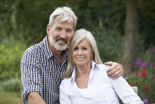 Portrait Of Mature Couple Relaxing In Garden Together
