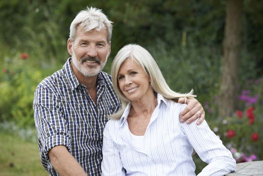 Portrait Of Mature Couple Relaxing In Garden Together