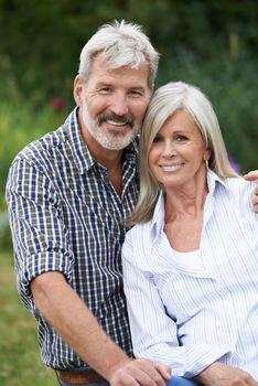 Portrait Of Mature Couple Relaxing In Garden Together