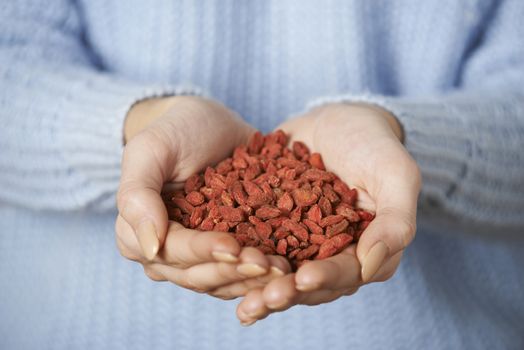Close Up Of Woman Holding Handful Of Goji Berries