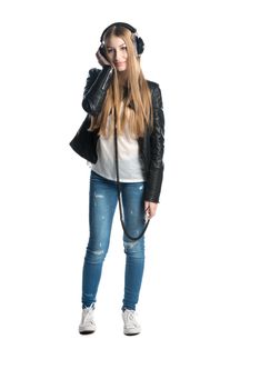 The isolated on white portrait of a teenager girl in wired headphones listening and enjoying music from personal portable device