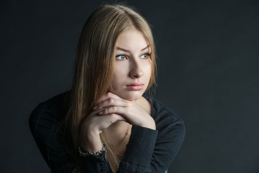 Spiritual and mental studio portrait of the Russian beautiful teenage girl with light long hair