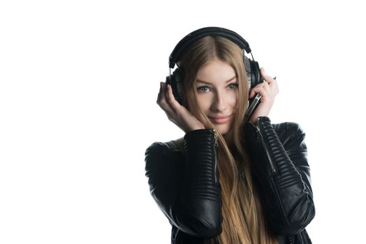 The isolated on white portrait of a teenager girl in wired headphones listening and enjoying music from personal portable device