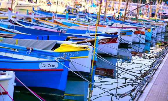 Nice, France - June 08, 2019 - Fishing boats docked in the port along the French Riviera on the Mediterranean Sea at Nice, France.