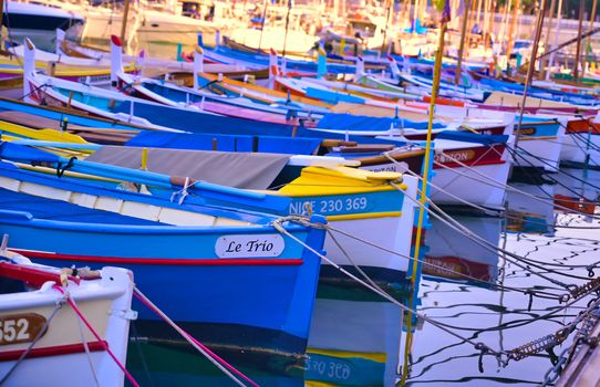 Nice, France - June 08, 2019 - Fishing boats docked in the port along the French Riviera on the Mediterranean Sea at Nice, France.