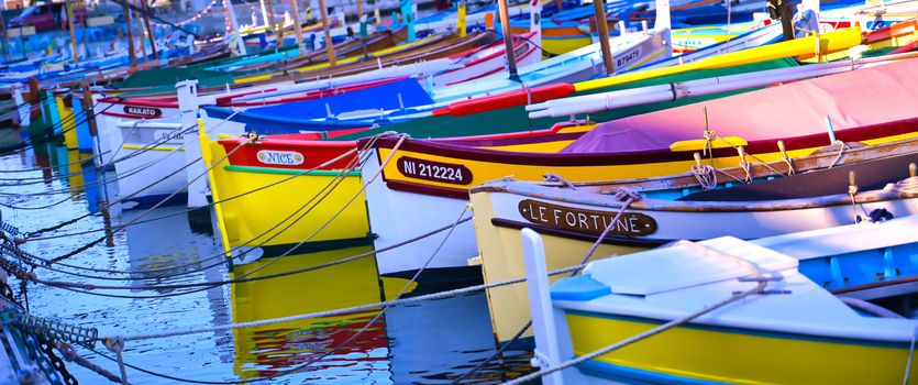 Nice, France - June 08, 2019 - Fishing boats docked in the port along the French Riviera on the Mediterranean Sea at Nice, France.