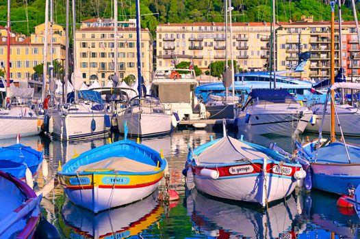 Nice, France - June 08, 2019 - Fishing boats docked in the port along the French Riviera on the Mediterranean Sea at Nice, France.