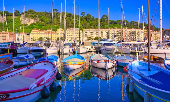 Nice, France - June 08, 2019 - Fishing boats docked in the port along the French Riviera on the Mediterranean Sea at Nice, France.