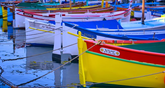 Nice, France - June 08, 2019 - Fishing boats docked in the port along the French Riviera on the Mediterranean Sea at Nice, France.