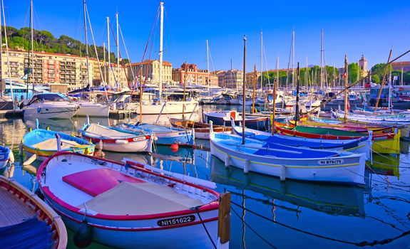 Nice, France - June 08, 2019 - Fishing boats docked in the port along the French Riviera on the Mediterranean Sea at Nice, France.