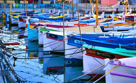 Nice, France - June 08, 2019 - Fishing boats docked in the port along the French Riviera on the Mediterranean Sea at Nice, France.