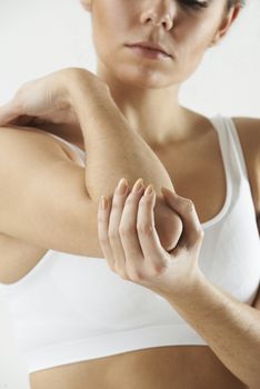 Studio Shot Of Woman With Painful Elbow