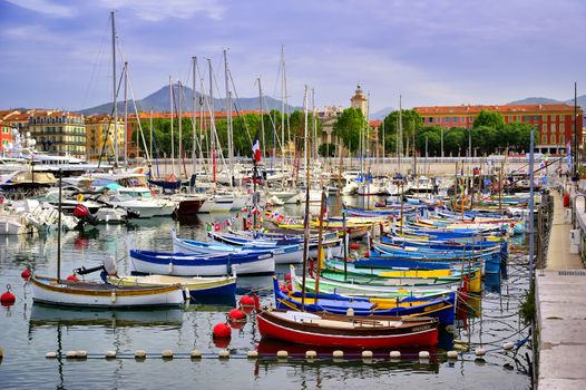 Nice, France - June 11, 2019 - Fishing boats docked in the port along the French Riviera on the Mediterranean Sea at Nice, France.