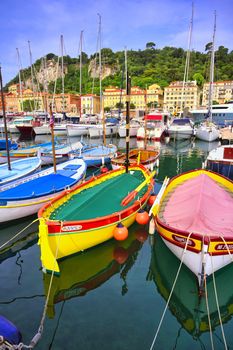 Nice, France - June 11, 2019 - Fishing boats docked in the port along the French Riviera on the Mediterranean Sea at Nice, France.