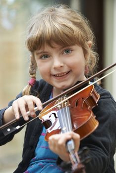 Young Girl Learning To Play Violin