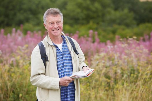 Senior Man Enjoying Hike In The Countryside