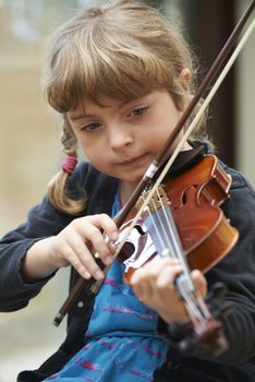 Young Girl Learning To Play Violin