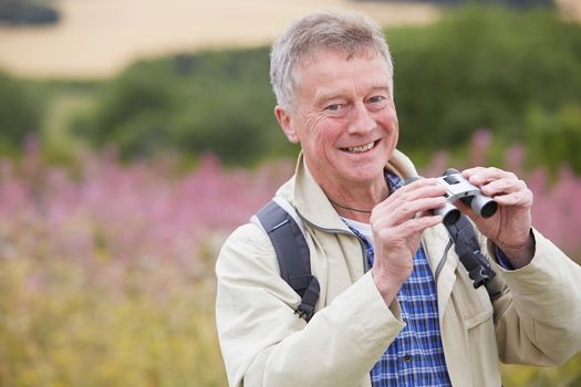 Senior Man On Walk With Binoculars