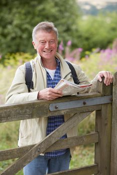 Portrait Of Senior Man Walking In Countryside