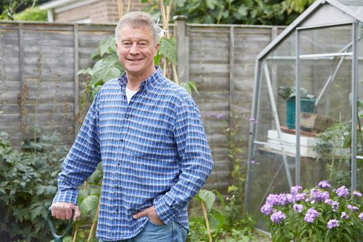 Portrait Of Man Gardening At Home