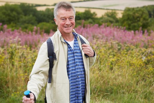 Senior Man Enjoying Hike In Countryside