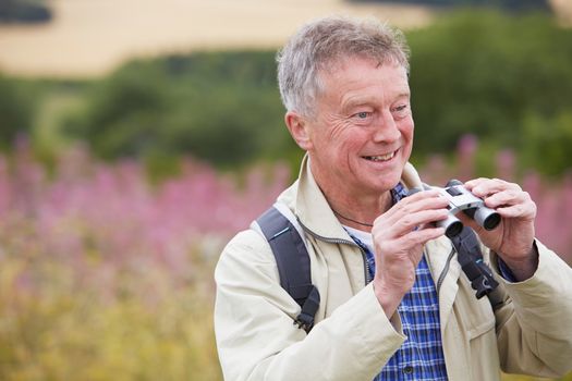 Senior Man On Walk With Binoculars