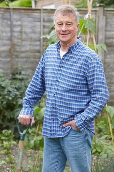 Portrait Of Senior Man Gardening At Home