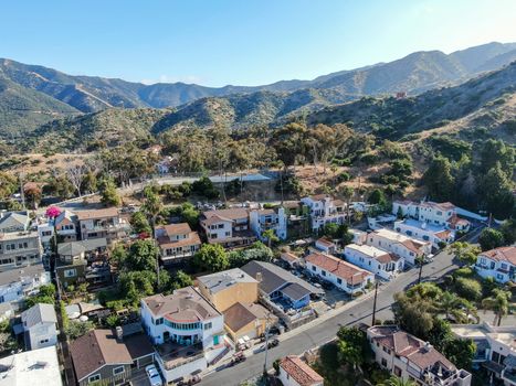 Aerial view of Avalon downtown with their houses on the cliff in Santa Catalina Island, famous tourist attraction in Southern California, USA