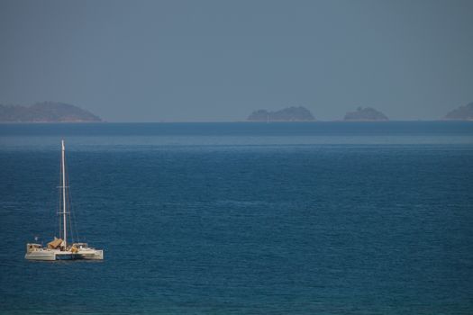 Yacht is parking in tropicana of sea at sunset is reflecting on water located at south of Thailand