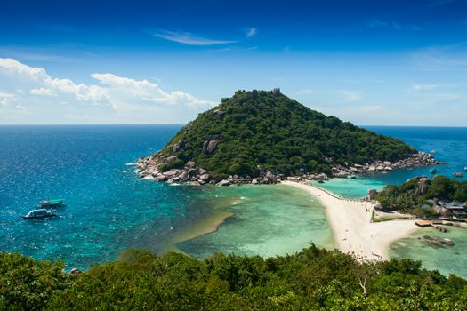 Landscape view point of separated sea across by white sand at front of green mountains under clear sky located at south of Thailand