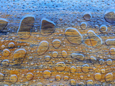 close-up water drops on a wooden surface