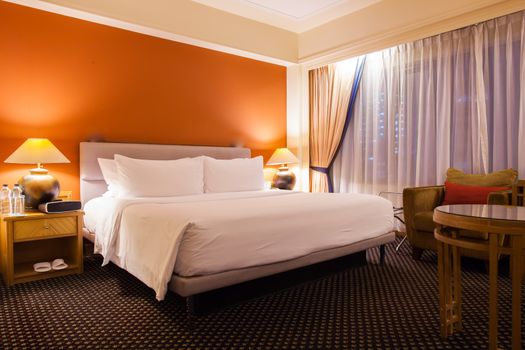 Interior of superior bedroom with white bed and pillow