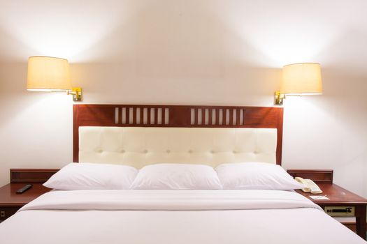 Interior of superior bedroom with white bed and pillow