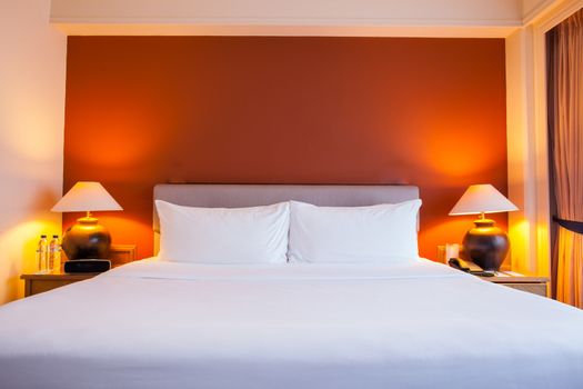 Interior of superior bedroom with white bed and pillow