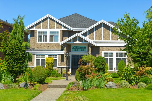 Luxury family house in suburban area of Vancouver, Canada. North American house on blue sky background on a sunny day.