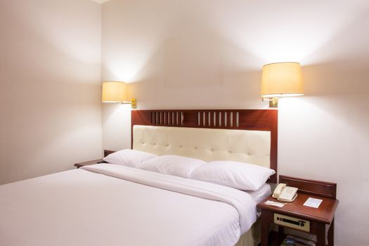 Interior of superior bedroom with white bed and pillow