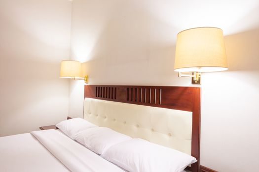 Interior of superior bedroom with white bed and pillow