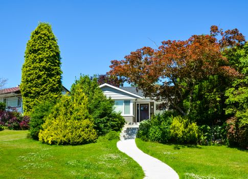 Concrete pathway to a family house on a sunny day in Vancouver, Canada