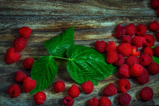 Macro photo raspberry berry. Texture background ripe pink raspberry berry. Fresh raspberries on a rustic wooden table. Selective focus.