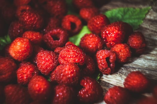 Macro photo raspberry berry. Texture background ripe pink raspberry berry. Fresh raspberries on a rustic wooden table. Selective focus. Bokeh.